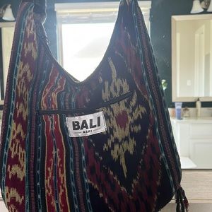 A cute little boho bag from Bali with some tussles.